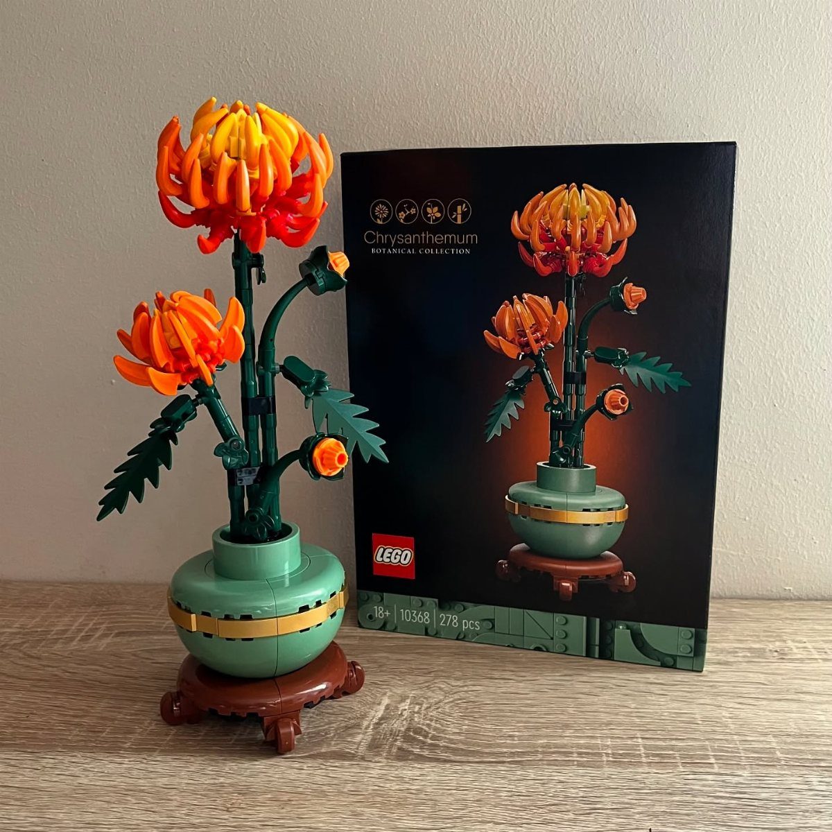 LEGO Botanicals Chrysanthemum flower model with orange petals in a green pot and box.
