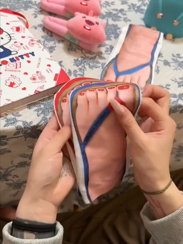 Novelty slippers resembling realistic human feet held by a person among other gifts.