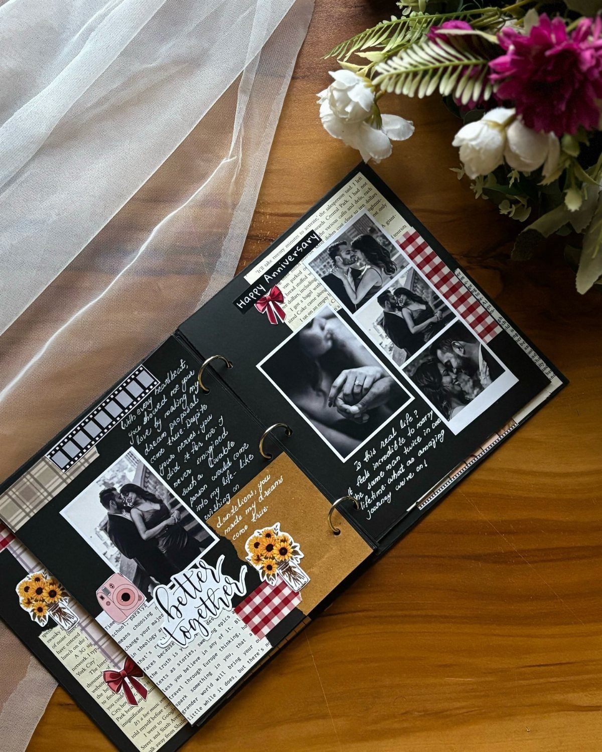 Open scrapbook with black and white couple photos, handwritten notes, and floral accents.