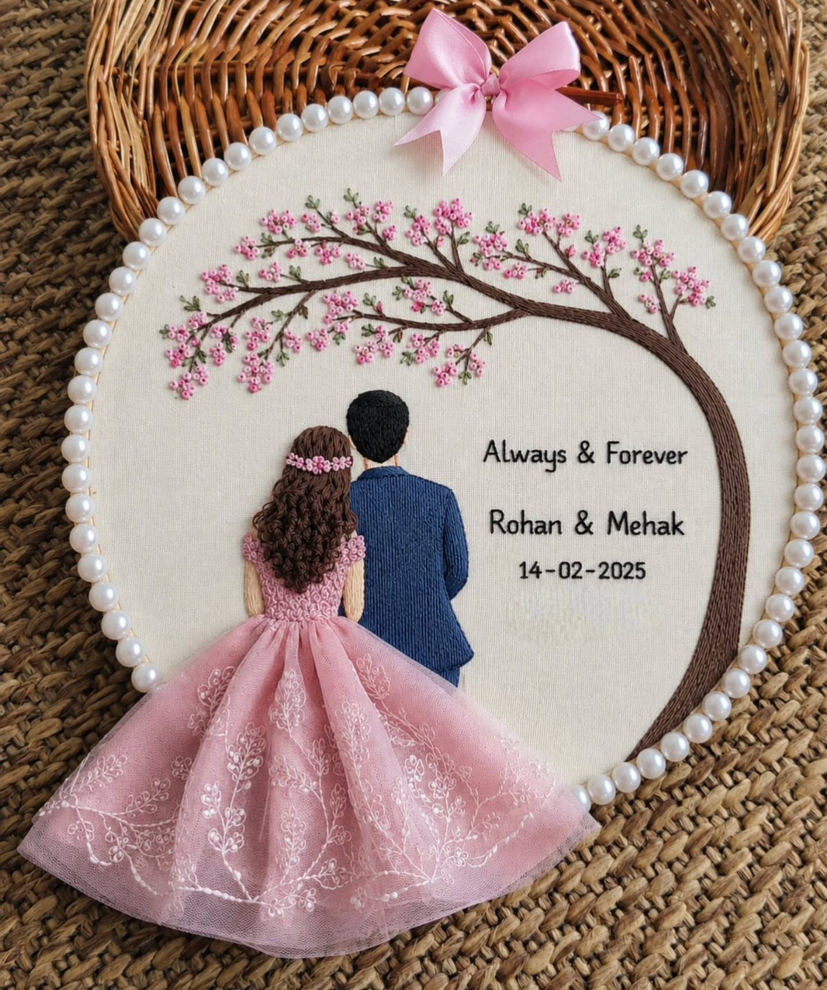 Embroidery hoop showing a couple under a pink tree with personalized anniversary text